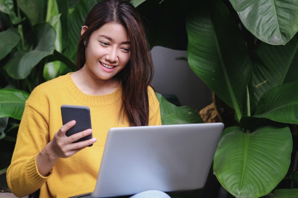 asian woman excited with sale promotion on website shop on laptop